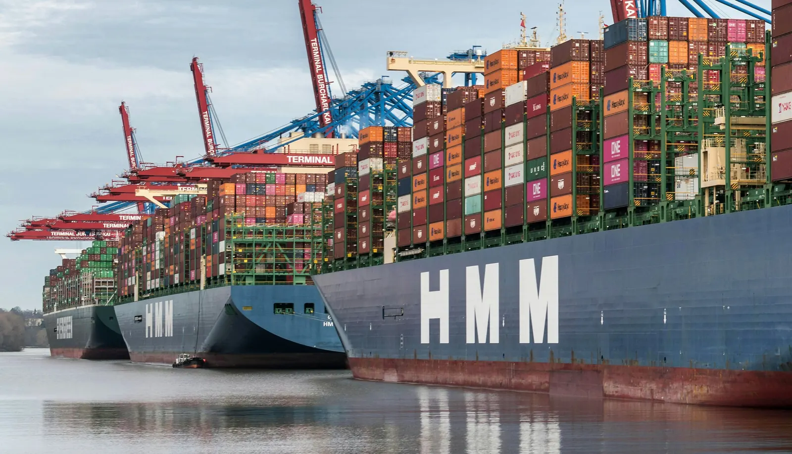 An HMM container ship at a container terminal, HMM on its hull