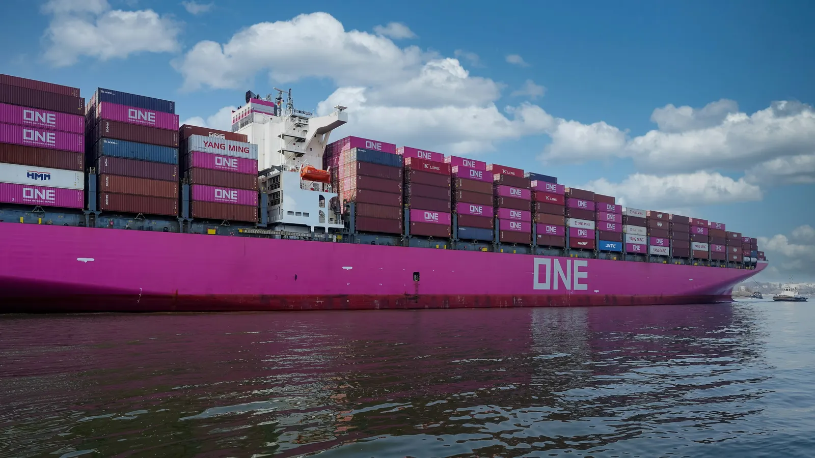 A magenta Ocean Network Express container ship, ONE on its hull