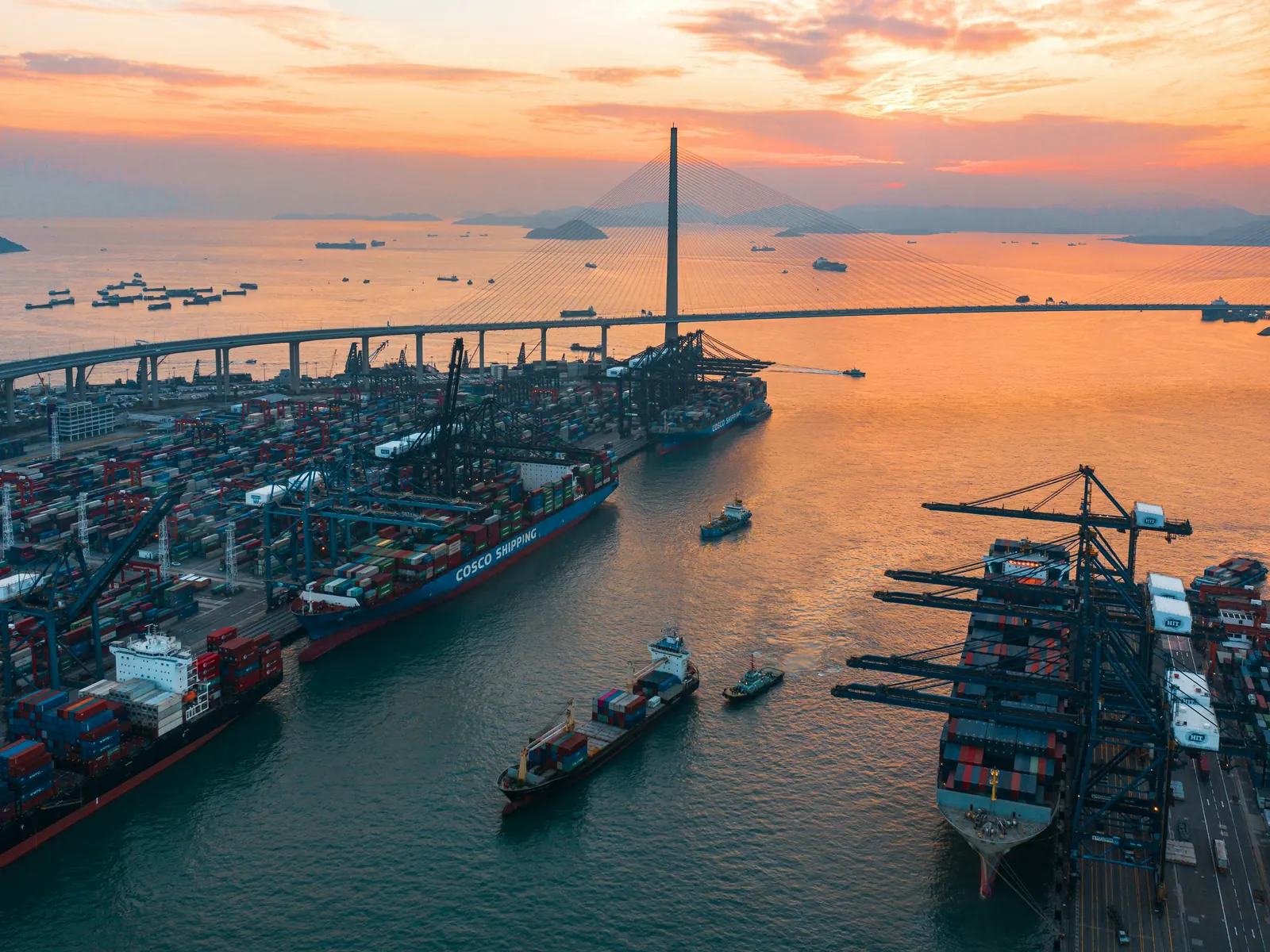 Aerial view of the Kwai Tsing container terminals and Stonecutters Bridge in Hong Kong at sunset