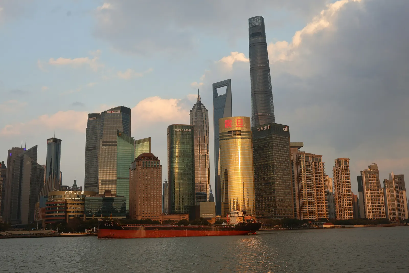 A cargo ship on the Huangpu River below the Pudong skyline in Shanghai